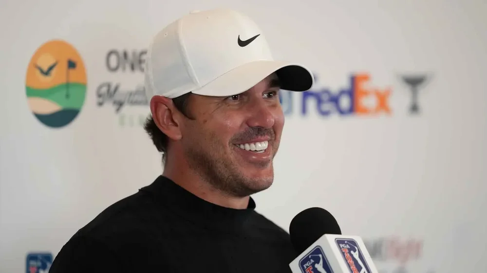 Brooks Koepka smiles while addressing the media